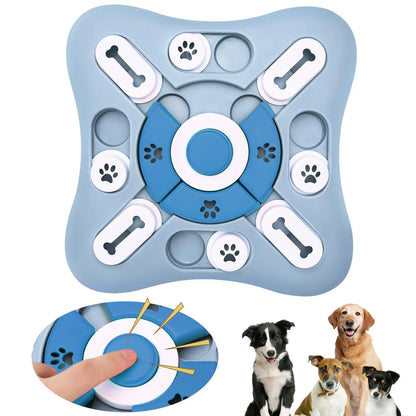 Blue and gray puzzle toy for dogs with paw and bone designs, shown with a hand holding it and three dogs below.