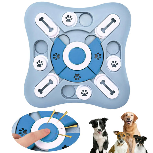 Blue and gray puzzle toy for dogs with paw and bone designs, shown with a hand holding it and three dogs below.