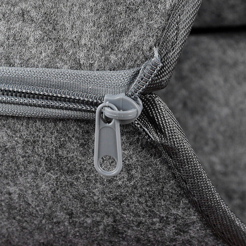 Close-up of a gray bag with a zipper on a textured surface