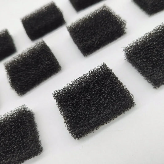 Black foam filters arranged on a white background